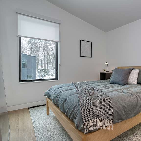 A modern building with a black facade and large windows. at The Grove Apartments, Ontario