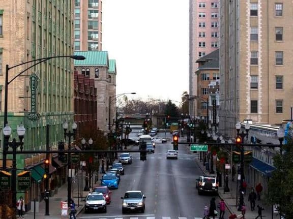 a busy city street with cars and traffic lights