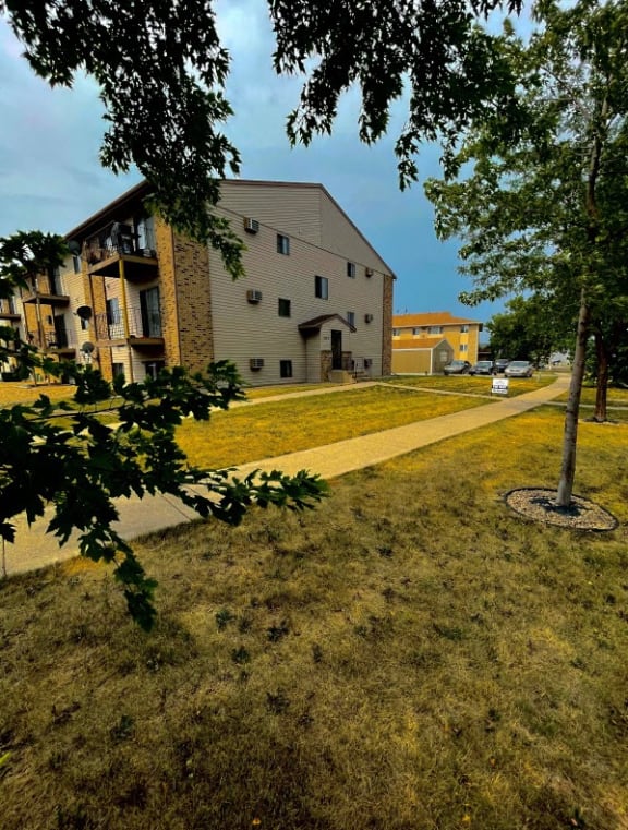 a building on the side of a grass field