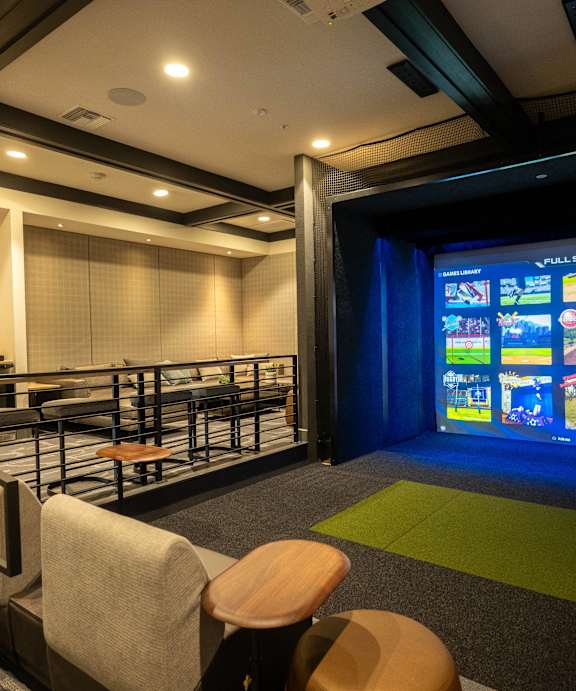 A room with a screen and chairs.