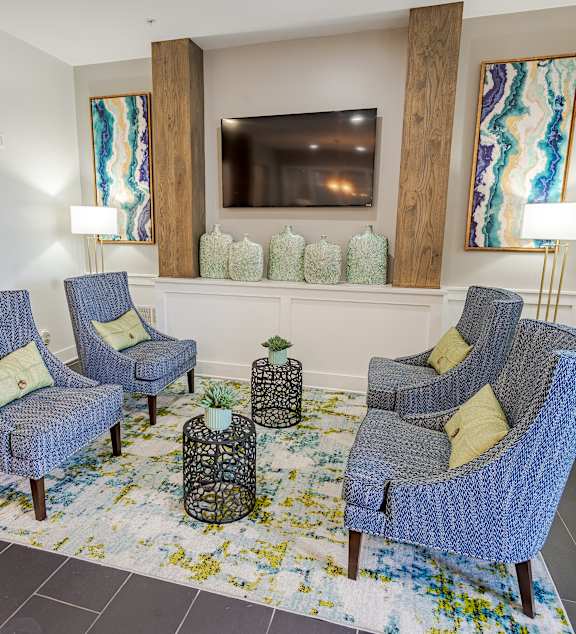 a living room with blue couches and a glass coffee table at The Greyson, Ohio, 43026
