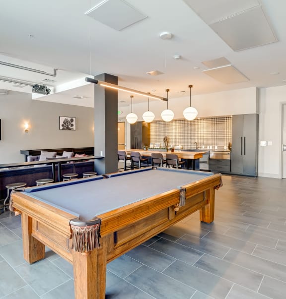 a pool table in the resident lounge at the bradley braddock road station apartments