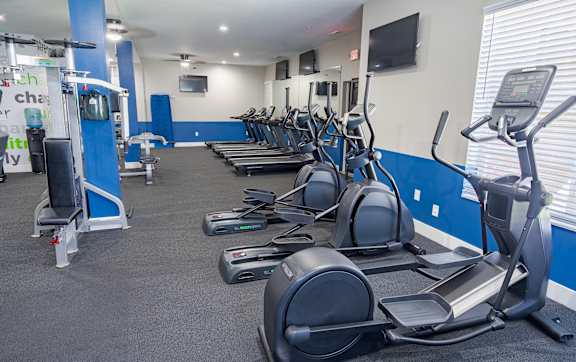 the gym has a wall of dumbbells and exercise equipment at The Greyson, Ohio, 43026