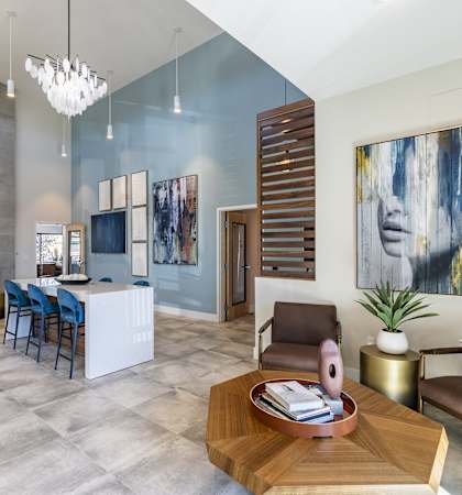 a living room and dining room with a table and chairs