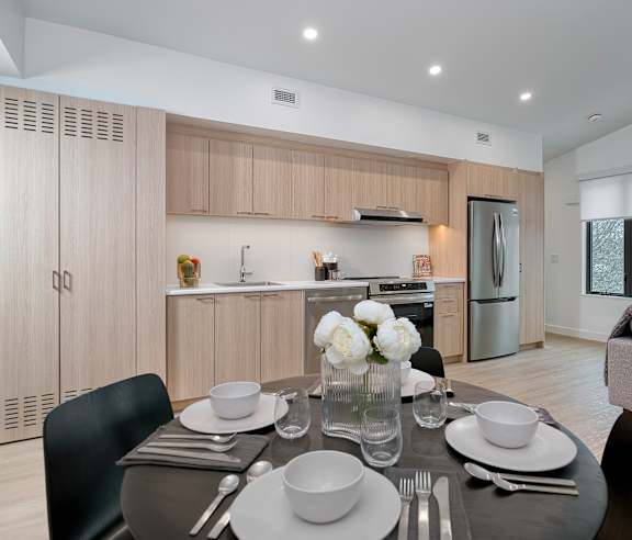 A store with a white interior and a variety of bags hanging on the wall. at The Grove Apartments, Ontario, L3V 1H4