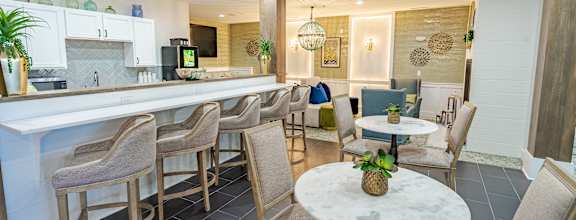 A modern kitchen with a bar area and seating.