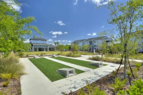 a park with benches and grass in front of a building