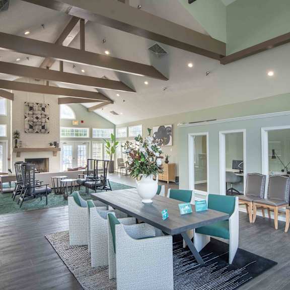 a large dining room with a table and chairs