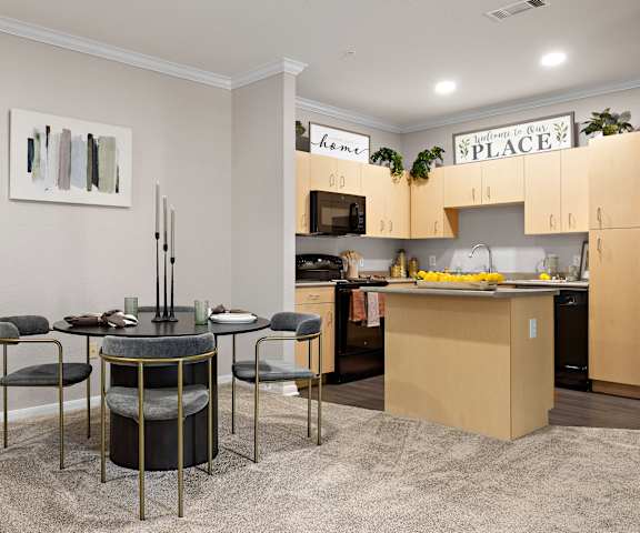 a living room with a kitchen and a dining table  at Artisan Apartments & Shops, Texas, 78729