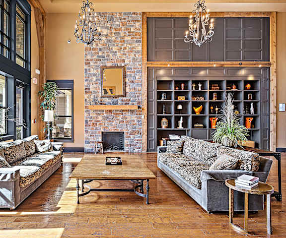 a living room with couches and a coffee table in front of a brick fireplace at Las Brisas Apartment Homes, Round Rock, 78665