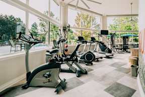 A person is riding an exercise bike in a gym. at Bridgwater, Greenwood Village, CO, 80111
