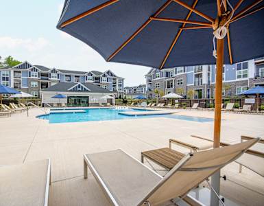 our apartments offer a swimming pool with chairs and umbrellas