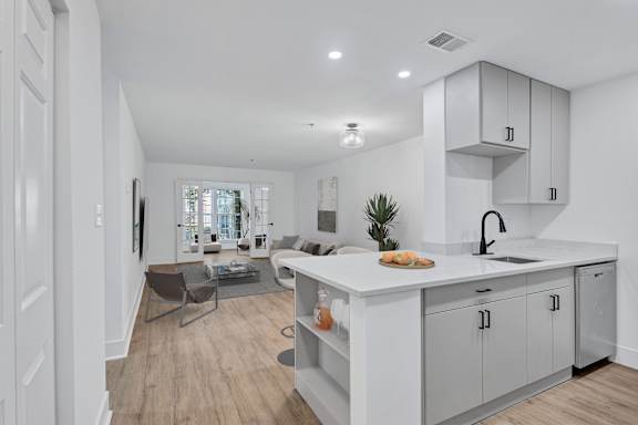 A modern kitchen with white cabinets and a large island.