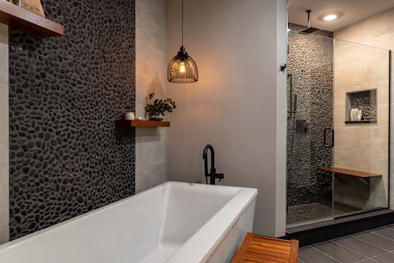 the master bathroom has a large tub and a walk in shower