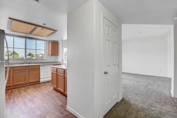 a kitchen and living room with white walls and wood floors at Aspen Peak, Nevada, 89011