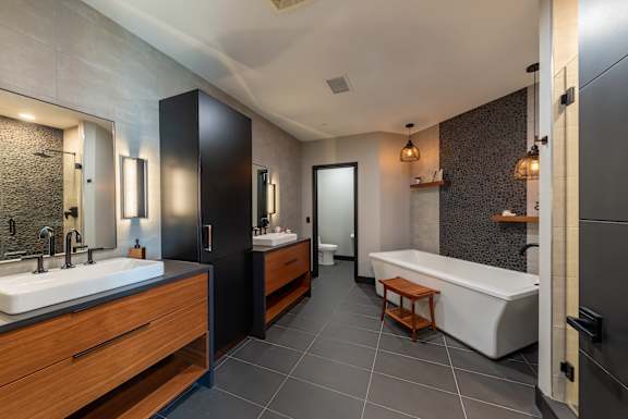 a bathroom with a tub and a sink and a mirror