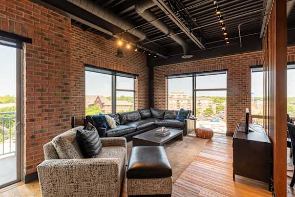a living room with a leather couch and a coffee table