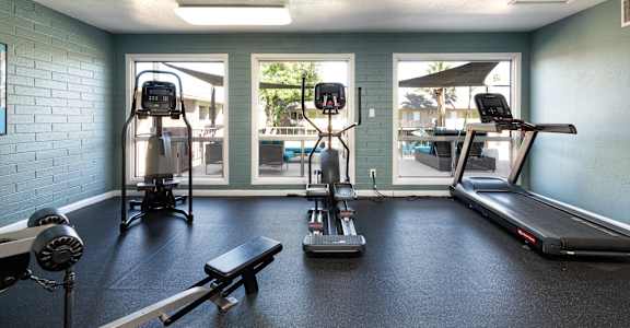 a fitness room with weights and cardio equipment at our apartments