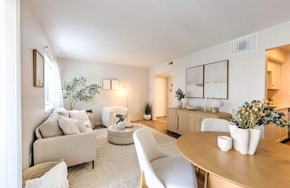 A well-lit, modern living room with a neutral color scheme and contemporary furniture.