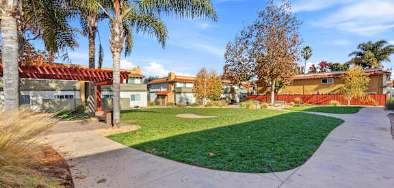 A residential area with houses and palm trees.