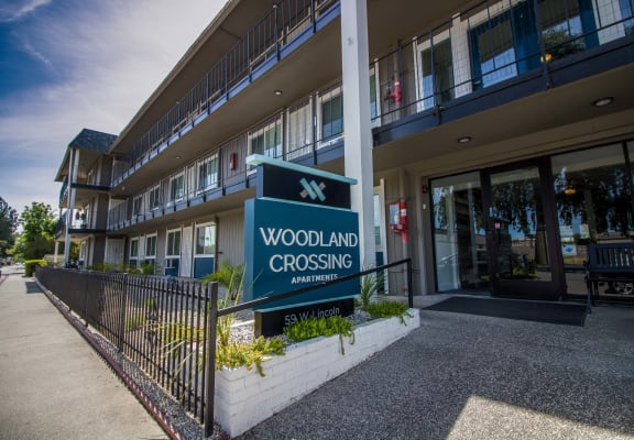 a building with a woodland crossing sign in front of it at Woodland Crossing , Woodland, CA 95695