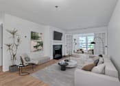 Thumbnail 3 of 25 - A modern living room with a fireplace and a large painting on the wall.