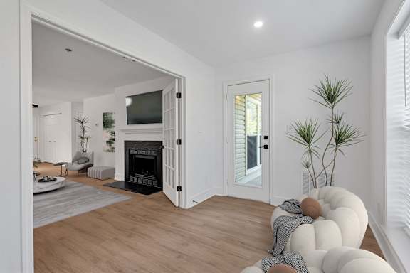 A modern living room with a fireplace and a television.