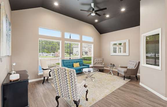 A living room with a patterned chair in the center.