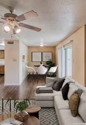 a living room with a couch and a coffee table in front of a tv at Village Oaks Apartments, Austin, Texas