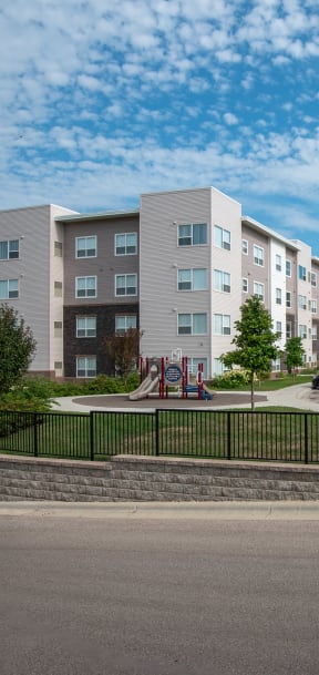an empty parking lot in front of an apartment building