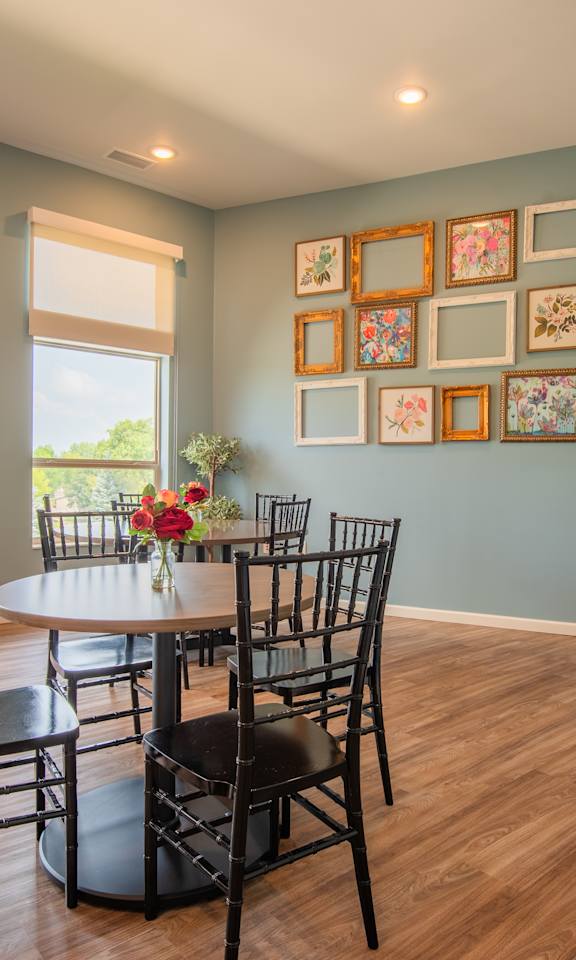 A dining room with a table set for six and a bench.