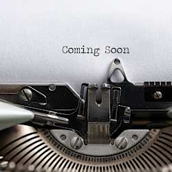 A vintage typewriter with the words "Coming Soon" typed on a piece of paper.