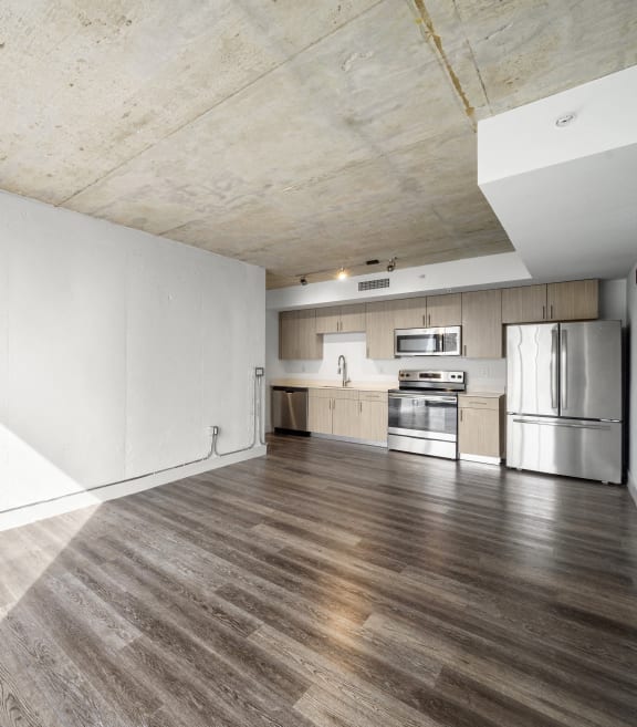 a large living room with white walls and wood floors