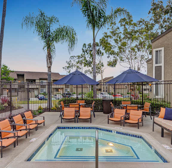 A pool surrounded by chairs and umbrellas.