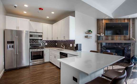 A modern kitchen with a large island and stainless steel appliances.