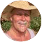 A man with a mustache and wearing a straw hat.