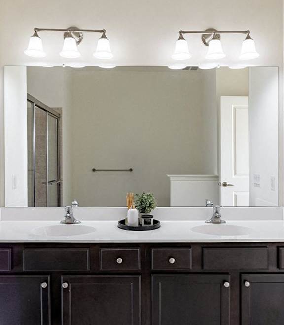 A bathroom with two sinks and a mirror.