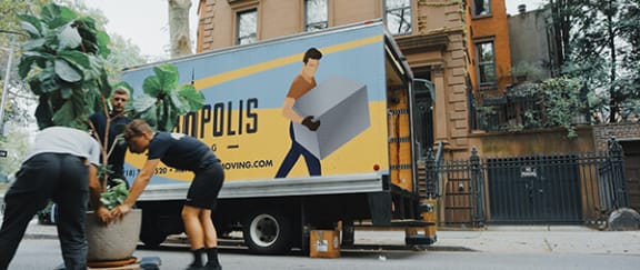 a couple of people standing next to a truck