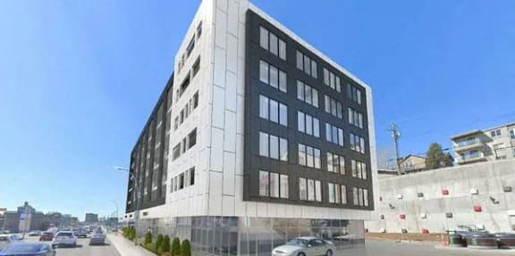 a tall white building sitting on the side of a street