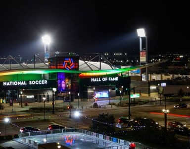 A night view of a soccer stadium with the words at Civic at Frisco Square Apartments, Frisco, TX