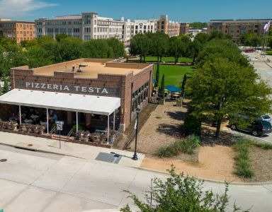 A Pizzeria Testa restaurant is located in a roundabout at Civic at Frisco Square Apartments, Frisco