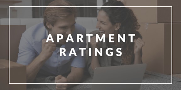 Two people looking at a laptop with the words "APARTMENT RATINGS" on the screen.