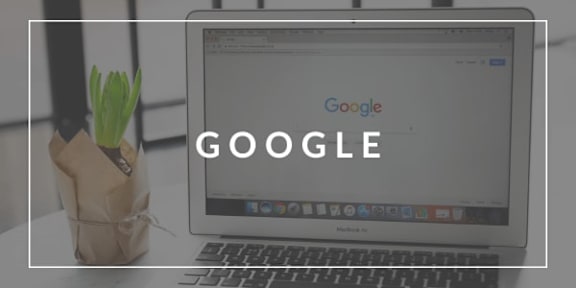 A laptop with the Google logo on the screen.