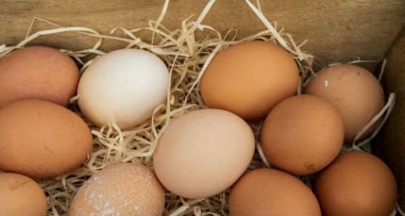 a bunch of eggs in a wooden box
