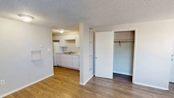 A kitchen area with a refrigerator, microwave, and oven.