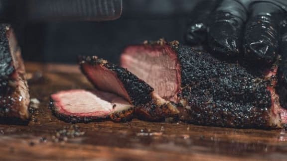 a steak on a cutting board with a knife