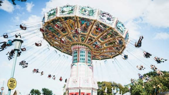 a ferris wheel at an amusement park with people on it