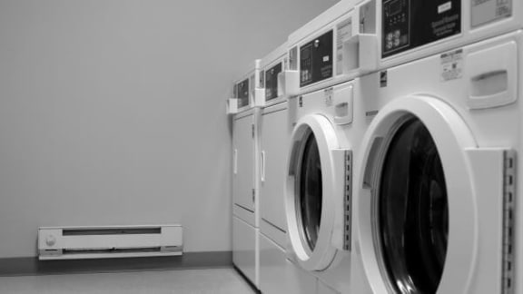 a row of washing machines in a laundromat