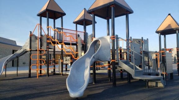 a childrens playground with a slide