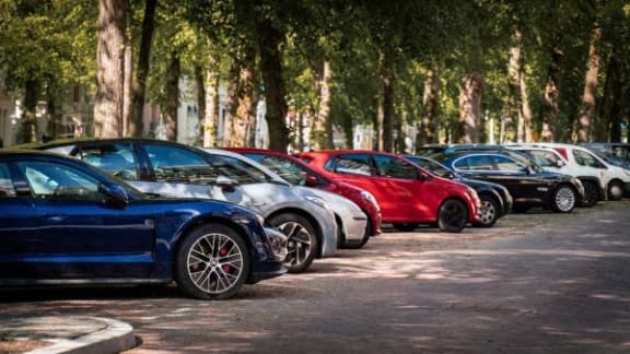 a row of cars parked in a parking lot